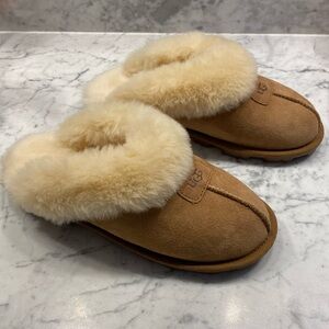 NWOT UGG slippers w/ fur. Never worn, but comfy, just not me. Size 7, no box.